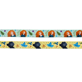 The Sassy Woof Harness Three Piece Bundle - Disney's Merida includes two decorative ribbons: the top with Merida among flowers and leaves, and the bottom displaying a black bear, blue bird, and nature motifs on yellow.