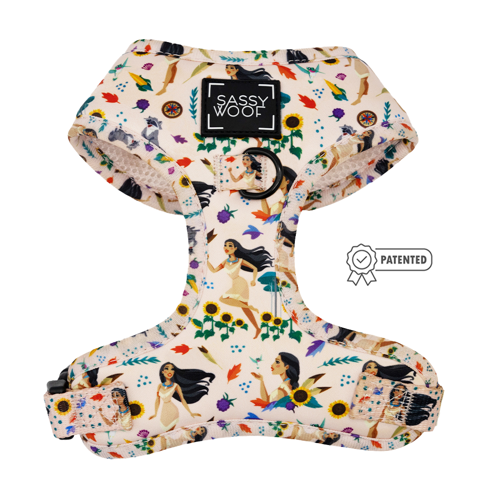 The Sassy Woof Disney's Pocahontas Dog Adjustable Harness features floral and cartoon Pocahontas prints, a black brand label, and patented details—ideal for pups in the Puppy Growth Pawtection Plan.