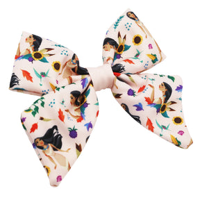 The Dog Sailor Bow - Disney's Pocahontas by Sassy Woof is a large, pale pink hair bow featuring women, sunflowers, leaves, and acorns—an adventurous accessory that pairs perfectly with your dog's Disney Pocahontas collar.