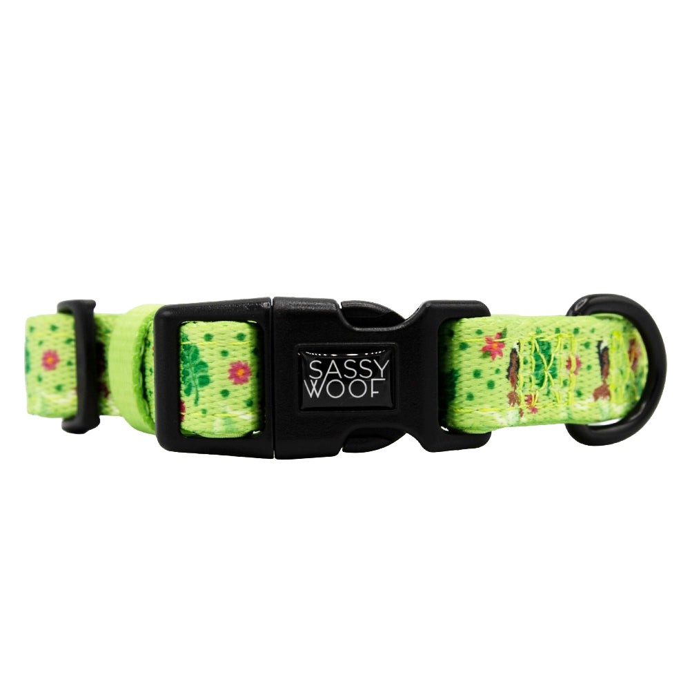 The Sassy Woof Harness Three Piece Bundle - Disney's Tiana features a green floral design inspired by Princess and the Frog, with a black buckle and "Sassy Woof" tag—perfect for stylish pups.