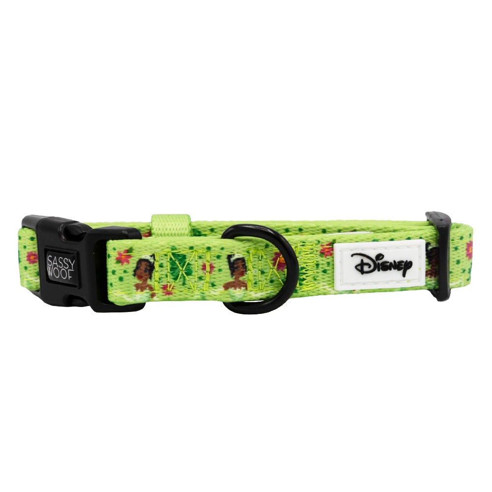 The Sassy Woof Dog Collar - Disney's Tiana is a green collar with a black buckle, Disney character prints, and a logo patch. Pair it with the Princess and the Frog harness or any matching Disney dog harness from Sassy Woof.