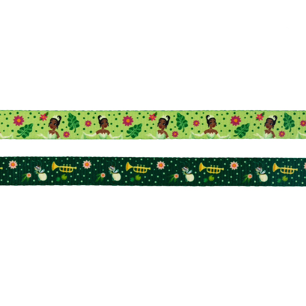 The Sassy Woof Dog Leash - Disney's Tiana features a light green ribbon with a girl with a bun, pink flowers, and green leaves, plus a dark green ribbon with trumpets, frogs, fireflies, and white flowers—ideal for Disney dog accessories.