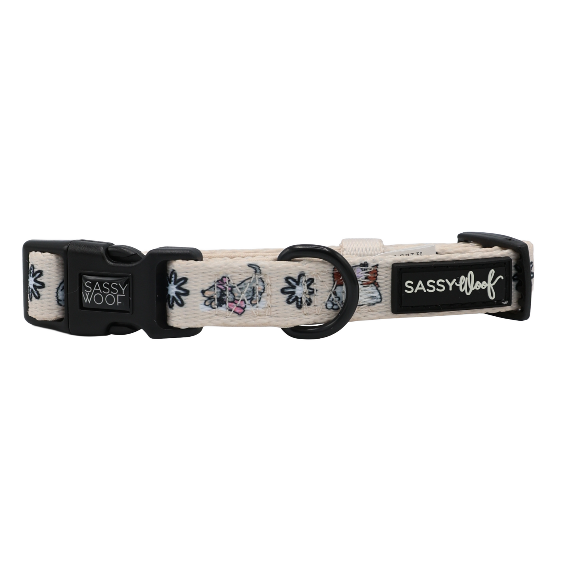 Introducing the Sassy Woof Dog Four Piece Bundle from the Weenie Wonderland Collection: a light-colored dog collar adorned with charming small dog and leaf illustrations, featuring a black buckle and D-ring. The collar displays Sassy Woof branding on two black tags and can be perfectly paired with the matching adjustable harness for a coordinated look.
