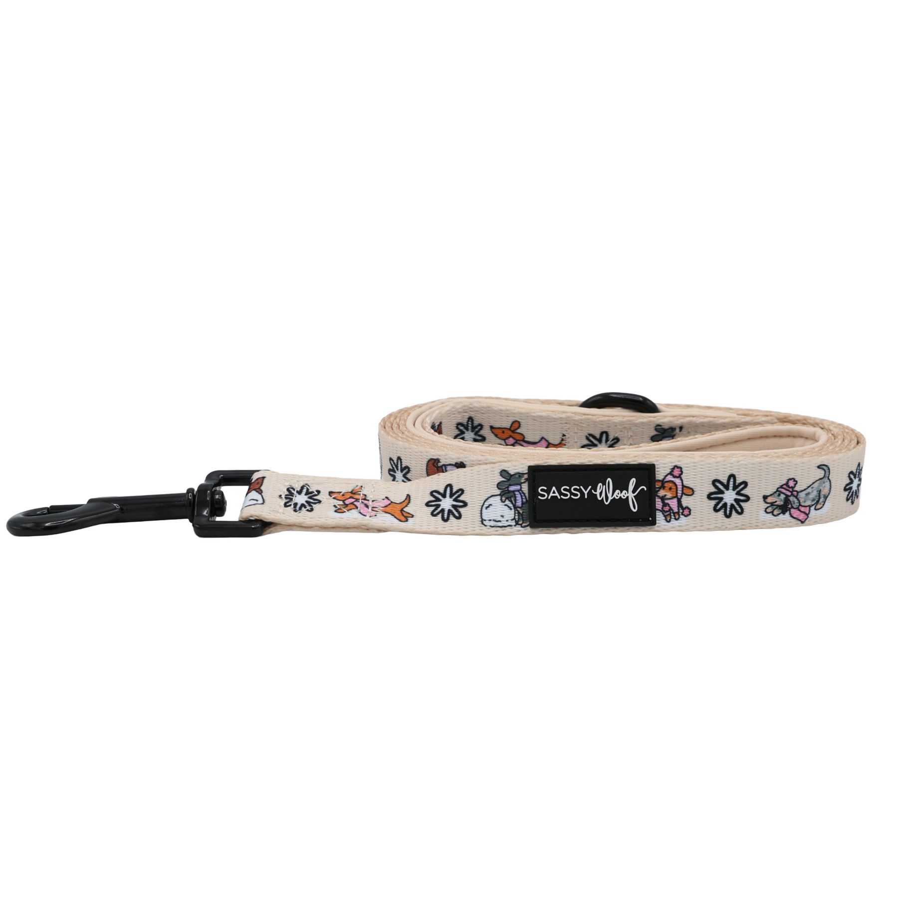 The Sassy Woof Dog Leash - Weenie Wonderland features a rolled-up beige design with a black clasp, adorned with small colorful cartoon animals and flowers, and finished with a black Sassy Woof label—making it a delightful and playful piece for your pastel dog accessories collection.