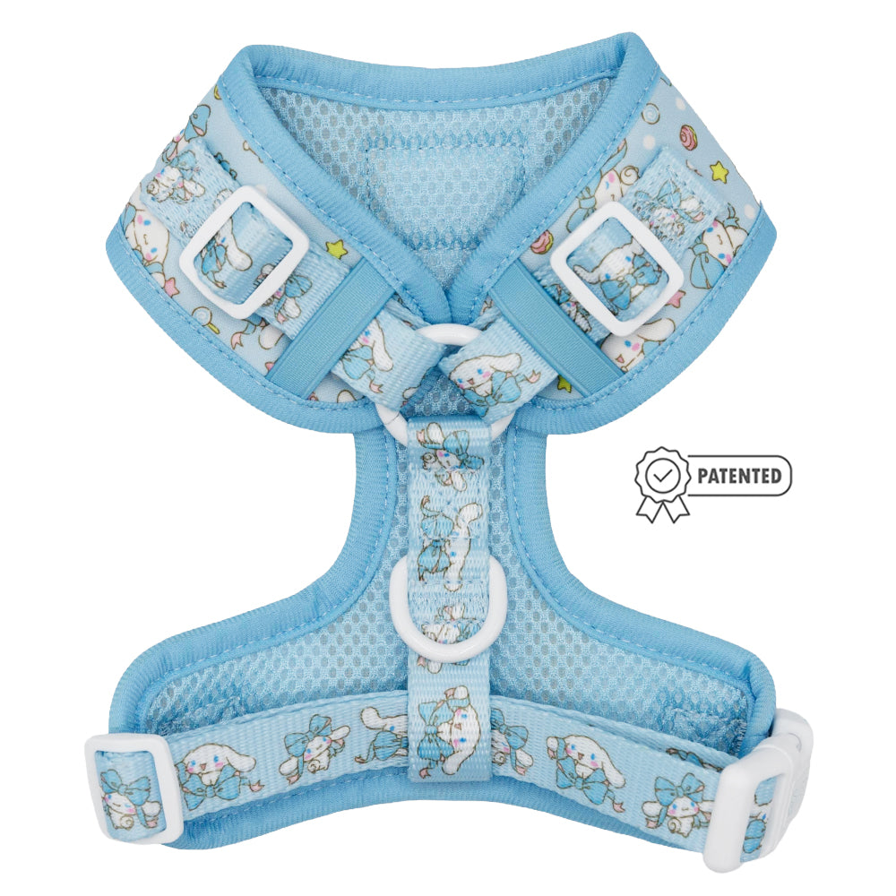 The Sassy Woof Dog Adjustable Harness - Cinnamoroll™ is a light blue no-pull harness featuring mesh fabric, white buckles, and a cute pattern with bunnies and stars, plus a patented badge on the side.