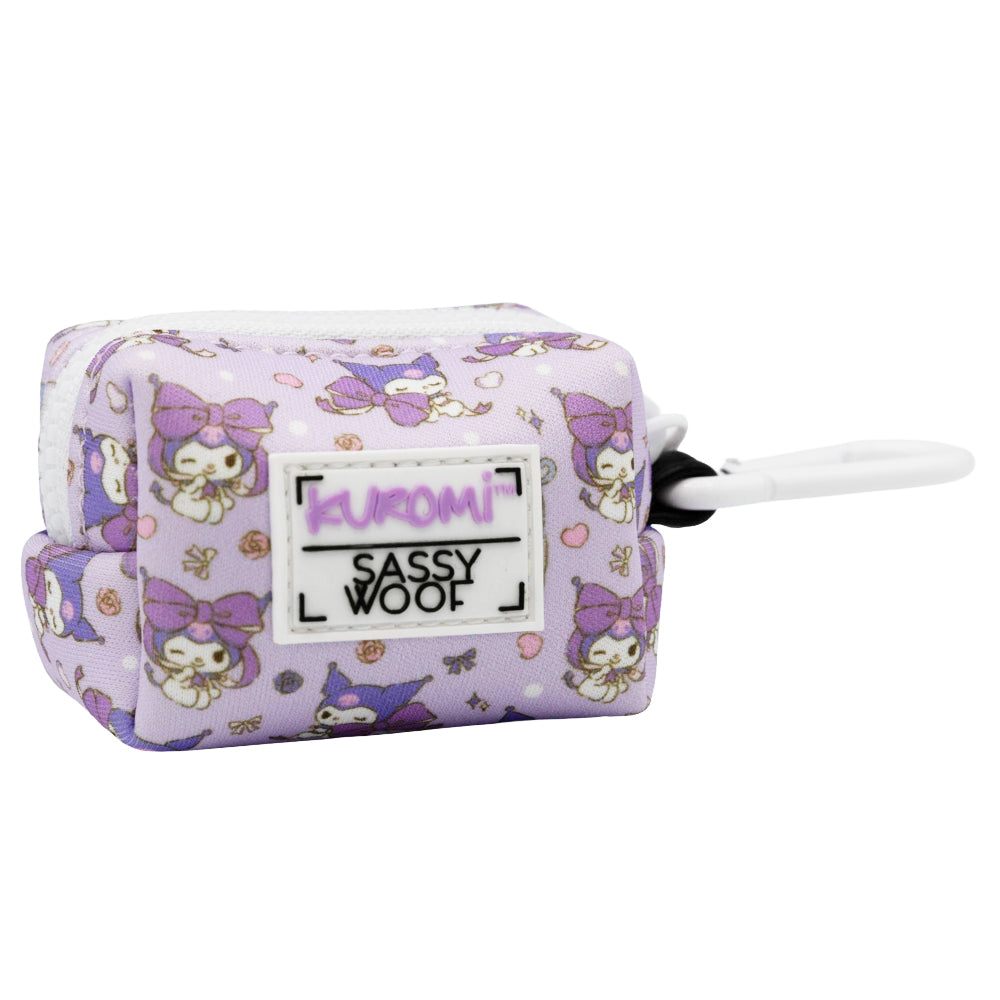 The Dog Waste Bag Holder - Kuromi™ by Sassy Woof features a small, rectangular, lavender neoprene design with a My Melody Kuromi print, front Sassy Woof label, and white side clip—ideal for Hello Kitty dog collection fans.