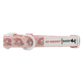 The Sassy Woof Dog Collar - My Melody™ is a pink adjustable collar featuring My Melody characters, a white plastic buckle, metal ring, and a label with MY MELODY™ and Sassy Woof—a must-have for Hello Kitty and My Melody fans.