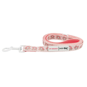 The Dog Leash - My Melody™ by Sassy Woof features a pink design with a white plastic clip and repeating My Melody™ cartoon pattern—perfect for Hello Kitty fans and their friends.