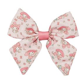 The Dog Sailor Bow - My Melody™ by Sassy Woof features a large pink bow with cartoon characters, musical notes, and flowers in a cute My Melody™ pattern—perfect for stylish dog accessories.