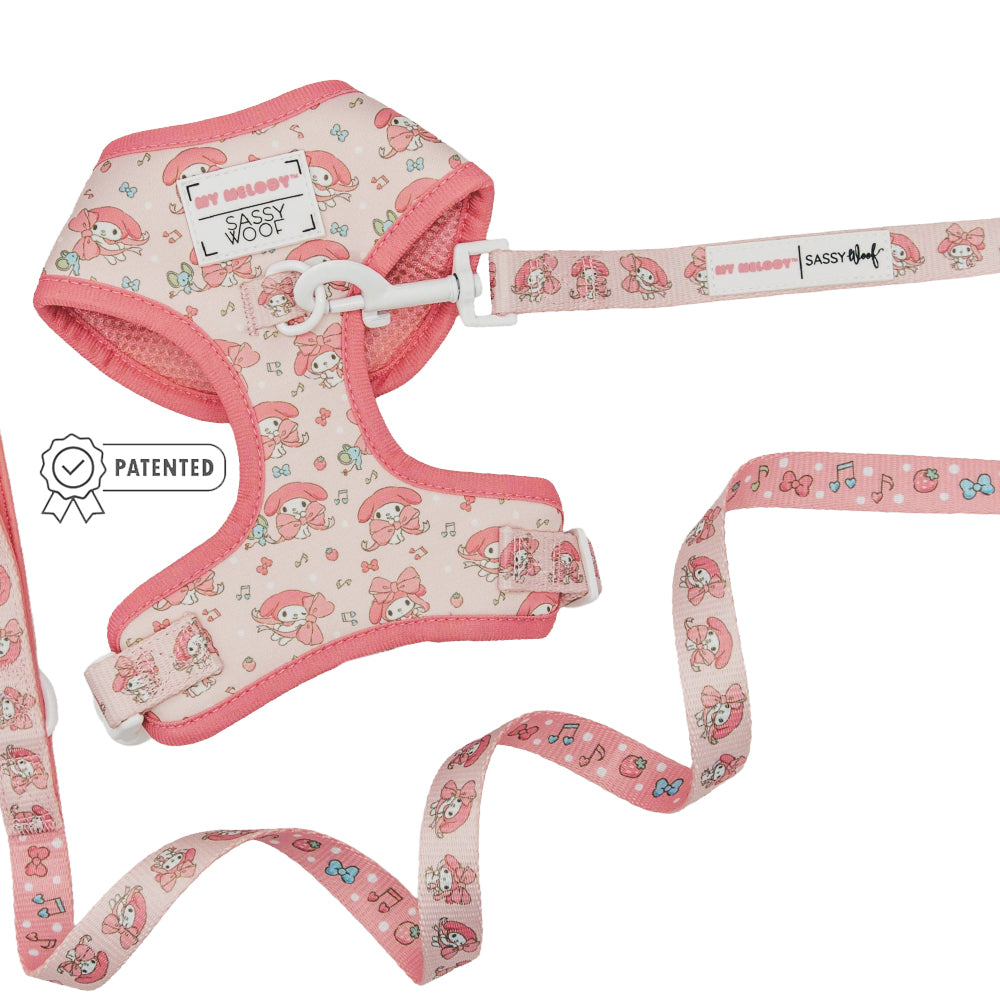 The Sassy Woof Dog Two Piece Bundle - My Melody™ features a pink adjustable harness and leash set with a cute bunny and music note design, plus a white buckle.