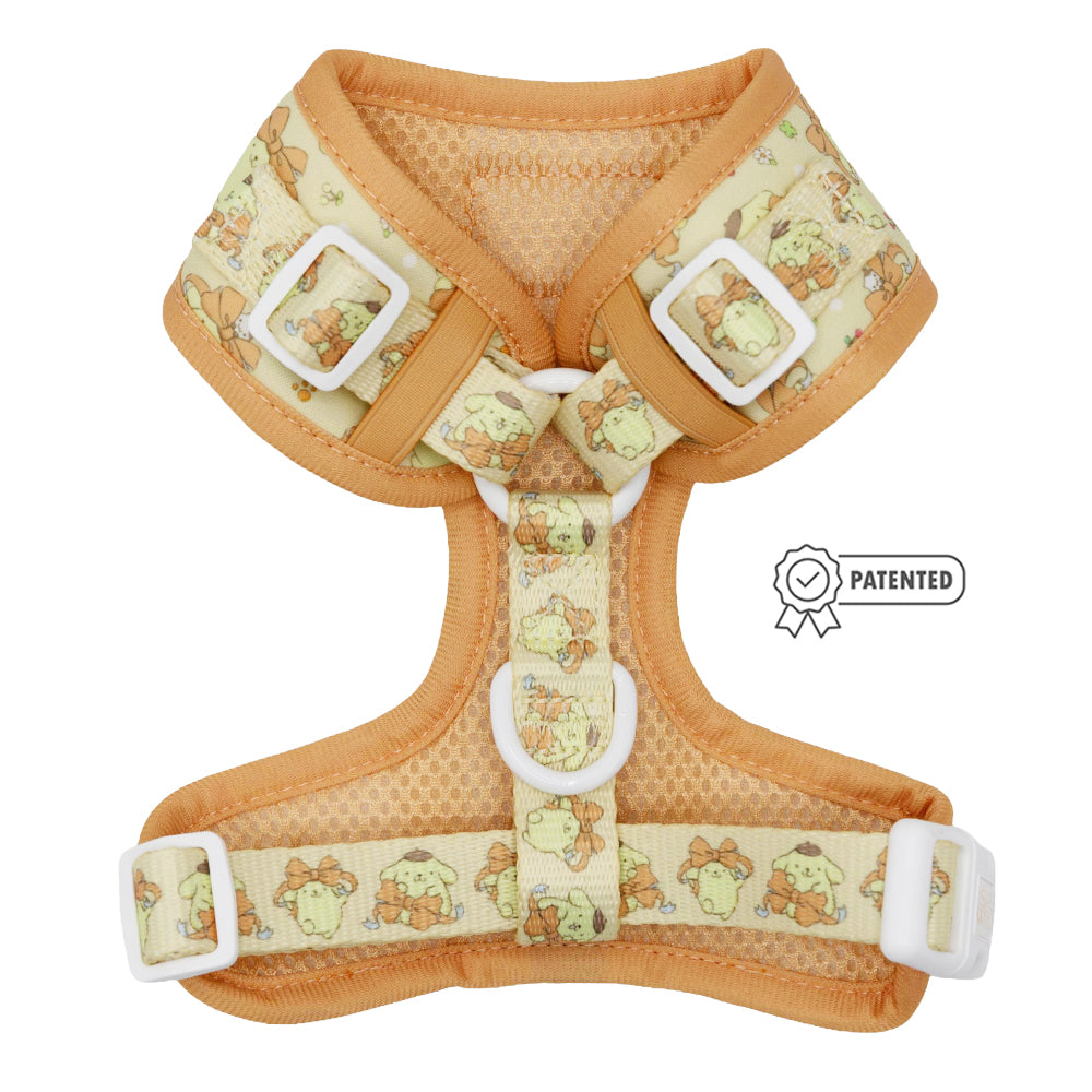 The Sassy Woof Dog Adjustable Harness - Pompompurin™ features a light orange frog and mushroom print, white buckles, and a "PATENTED" icon. Stylish and comfy for your pet. Compatible with the Puppy Growth Pawtection Plan.