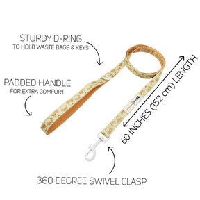 The Sassy Woof Dog Leash - Pompompurin™ features a cartoon dog print, padded neoprene handle, sturdy D-ring for bags or keys, 360° swivel clasp, and is 60" (152 cm) long. Labels highlight features to pair easily with an adjustable harness.