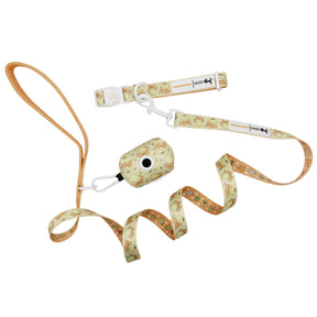 The Sassy Woof Collar Three Piece Bundle - Pompompurin™ includes a matching dog collar, tan-handled leash, and waste bag holder with a light beige cartoon dogs and bones pattern.
