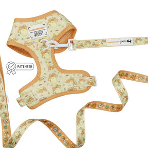 The Sassy Woof Dog Two Piece Bundle - Pompompurin™ features an adjustable yellow harness with cartoon chick and flower designs, a matching leash with a patented white clasp, and charming Sassy Woof and PATENTED labels.
