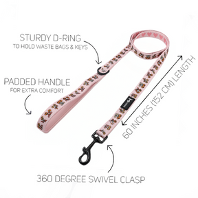 Introducing the Sassy Woof Dog Two Piece Bundle - Sassy Lil Pumpkins: This pink dog leash from the Sassy Lil Pumpkins collection features a charming heart and bone pattern, a comfortable padded handle, sturdy D-ring, and a 360-degree swivel clasp. Measuring 60 inches (152 cm) in length, it’s highlighted with arrows and text to showcase each feature. The perfect match for your favorite pumpkin dog harness or adjustable dog harness for a stylish stroll.