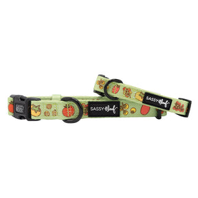 Two green Sassy Woof "Feeling Vine" dog collars with black buckles and plant-inspired designs featuring strawberries, watermelons, and pineapples.