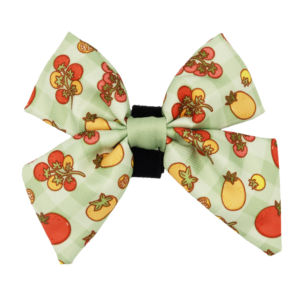 The Sassy Woof Dog Sailor Bow - Feeling Vine features a light green fabric with colorful tomato prints and a black center, perfect for pairing with the matching leash from our plant-inspired collection.