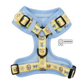 The Sassy Woof Dog Adjustable Harness - Patch Perfect features light blue fabric, yellow straps, bear and bee designs, honey pots, bows, black buckles, and a patented badge—ideal for your puppy's growth.