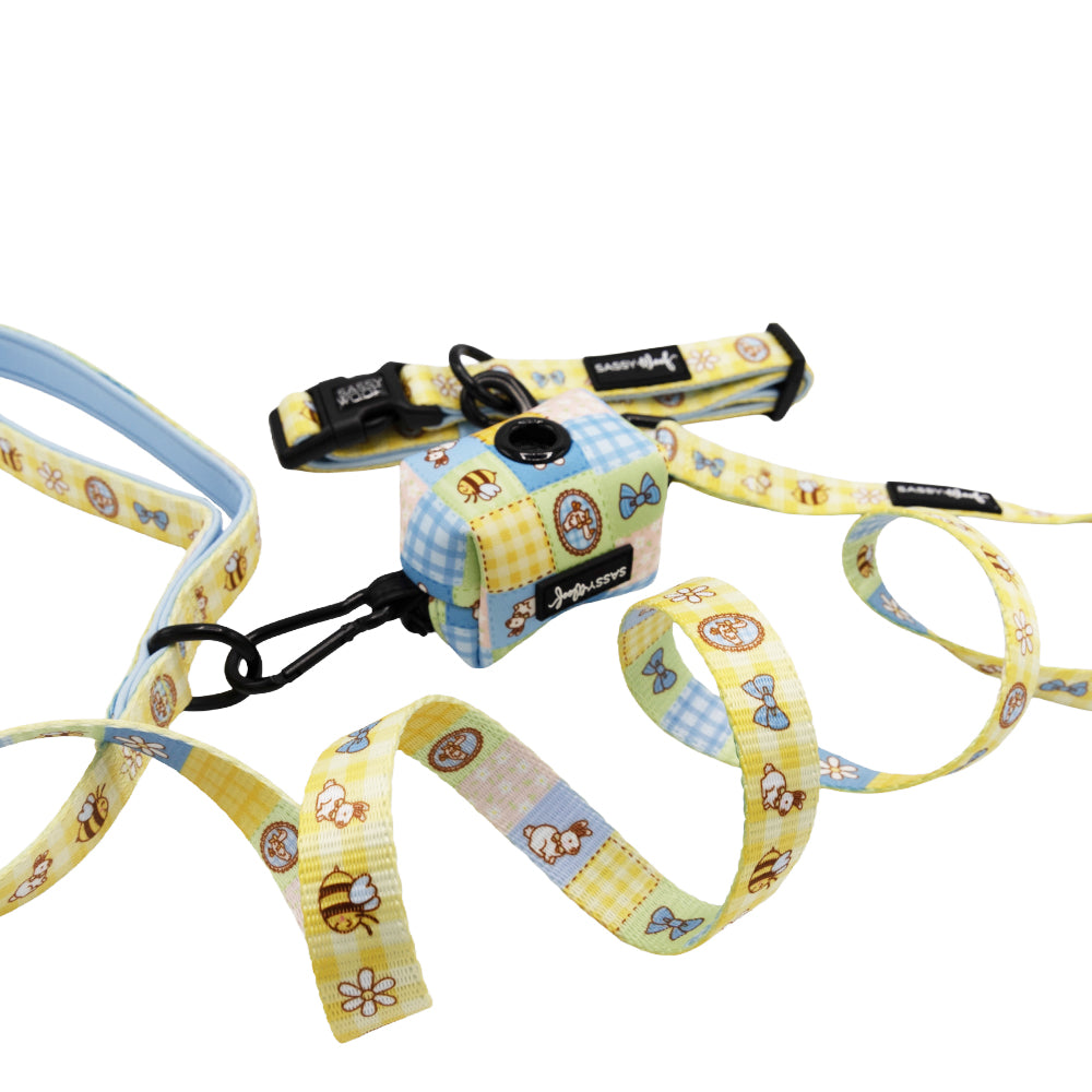 The Sassy Woof Dog Three Piece Bundle - Patch Perfect includes a pastel leash and matching waste bag holder with animal, flower, and picnic patterns, plus plastic clasps—pairs perfectly with our Patch Perfect collar.