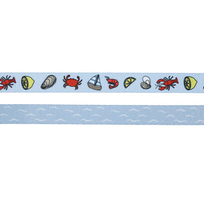 The Sassy Woof Dog Three Piece Bundle - Coastal Cuties features playful crabs, lemons, clams, sailboats, shrimp, and shells on light blue ribbon plus a matching wave design—perfect for a stylish leash and collar set.