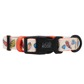 The Sassy Woof Dog Three Piece Bundle - Shell Yeah features a playful seashell pattern with orange accents on cream, and includes a colorful collar with a black plastic buckle.