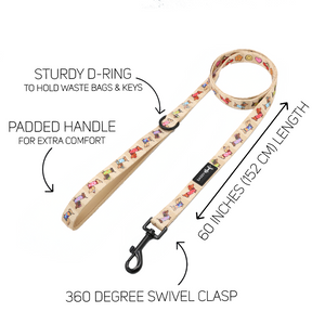Introducing the Sassy Woof Dog Two Piece Bundle - Sunbean: a beige dog leash adorned with vibrant, playful dog illustrations. It features a padded handle for comfort, a sturdy D-ring for accessories, and a durable black 360-degree swivel clasp. Measuring 60 inches (152 cm) in length, this leash is perfect for pairing with an adjustable harness or the coordinating Doxie pattern harness. Each key feature is thoughtfully designed to ensure both style and functionality.