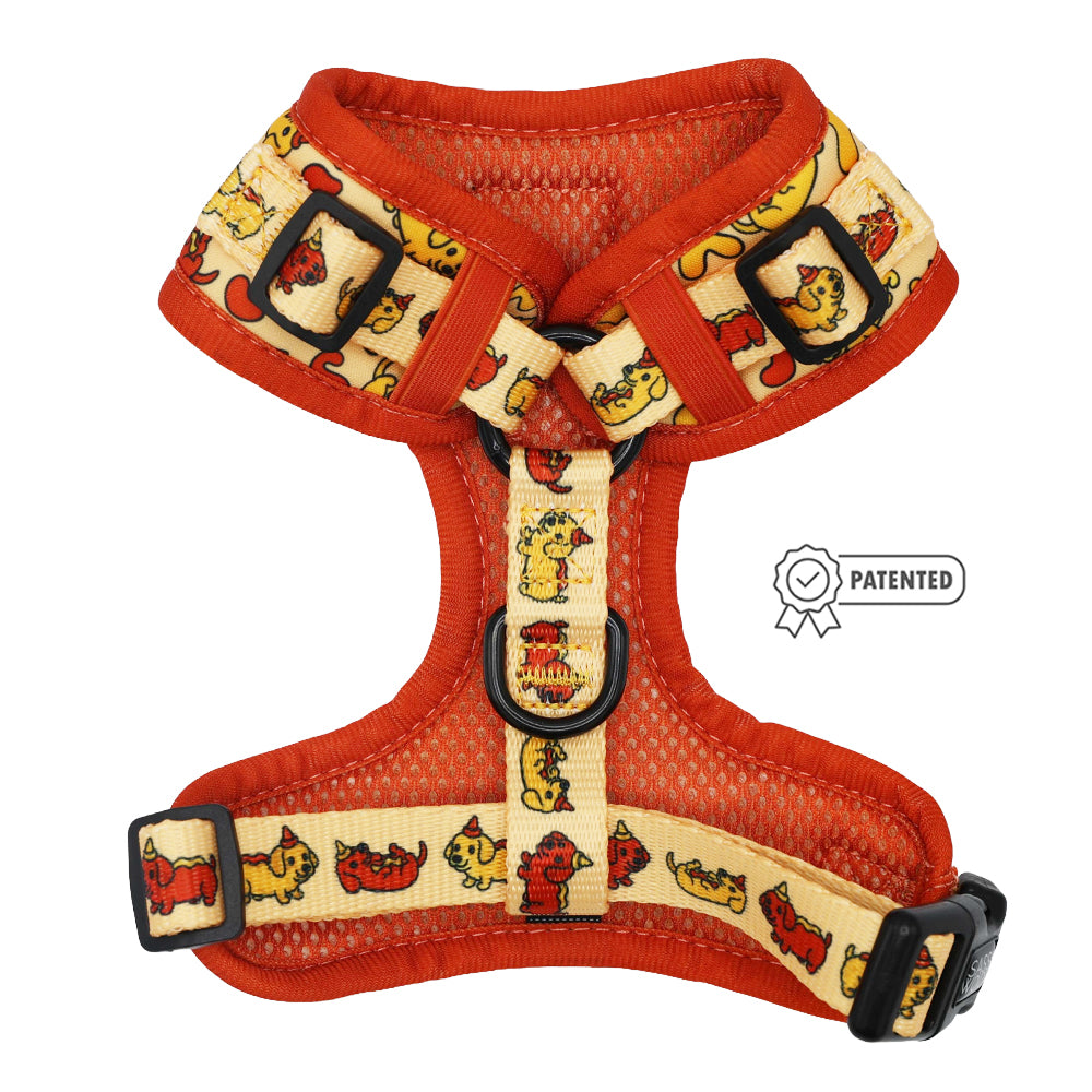The Sassy Woof Dog Adjustable Harness - Hot Dawg features a red and yellow design with cartoon dog illustrations, black buckles, and a patented badge—perfect as a playful accessory for your weenie dog.