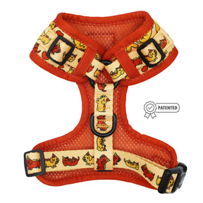 The Sassy Woof Dog Adjustable Harness - Hot Dawg features a red and yellow design with cartoon dog illustrations, black buckles, and a patented badge—perfect as a playful accessory for your weenie dog.