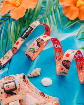 The Sassy Woof Dog Leash - Disney's Moana features animated characters and colorful floral patterns on a blue background with orange hibiscus flowers, palm leaves, and seashells for a fun tropical style.