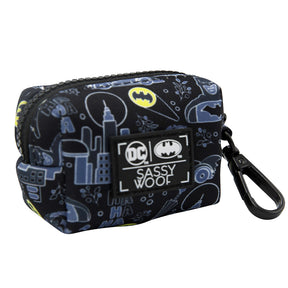 A compact, rectangular black pouch featuring Batman-themed graphics, a zippered top, and a convenient black clip—adorned with a Sassy Woof label alongside official DC and Batman logos. Designed to perfectly complement your Sassy Woof Dog Collar Three Piece Bundle - Batman™ for the ultimate superhero walk.