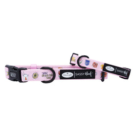The Sassy Woof Dog Collar - Gilmore Girls™ features a pink adjustable neoprene design with colorful patches, black plastic buckle, and metal rings—perfect for Gilmore Girls fans and their pups.
