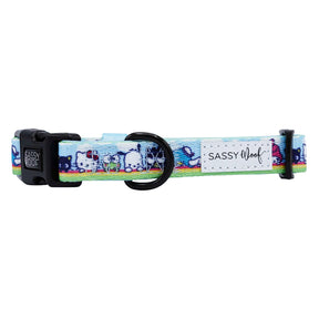 The Sassy Woof Dog Collar - Hello Kitty® & Friends In the Sky features a blue adjustable fit, plastic buckle, black D-ring, and white logo patch. Its playful design is ideal for fans seeking a fun Hello Kitty-themed collar.