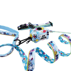 The Sassy Woof Collar Three Piece Bundle - Hello Kitty® & Friends In the Sky is shown coiled on a white background, featuring colorful cloud and character designs with a matching waste bag dispenser.