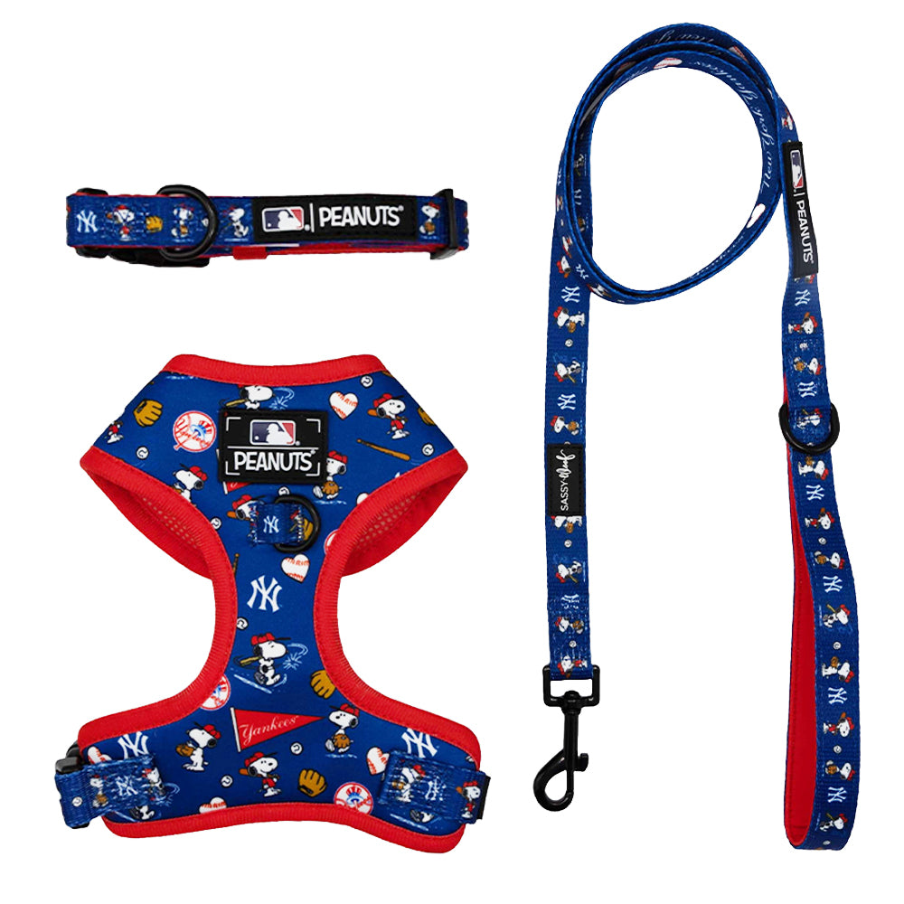 The Harness Three Piece Bundle - MLB x Peanuts™ New York Yankees™ by Sassy Woof features a blue Snoopy dog harness, collar, and leash with team logos and playful prints—ideal for fans seeking Puppy Growth Pawtection Plan style.