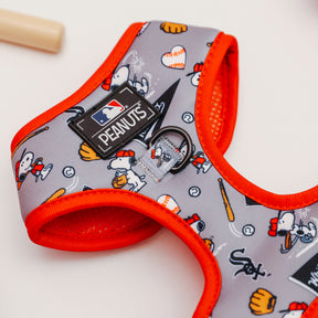 The Sassy Woof Harness Three Piece Bundle - MLB™ x Peanuts™ Chicago White Sox™ features Snoopy in baseball gear, balls, bats, gloves, and team logos with orange trim—perfect for your puppy’s growth.