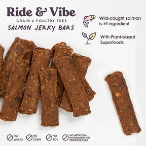 Sassy Woof Bundle x Joy Salmon Superfood Jerky Bars are arranged on a white surface, with text highlighting they’re grain and poultry free, made with wild-caught salmon and plant-based superfoods, with no wheat, corn, soy or artificial ingredients.