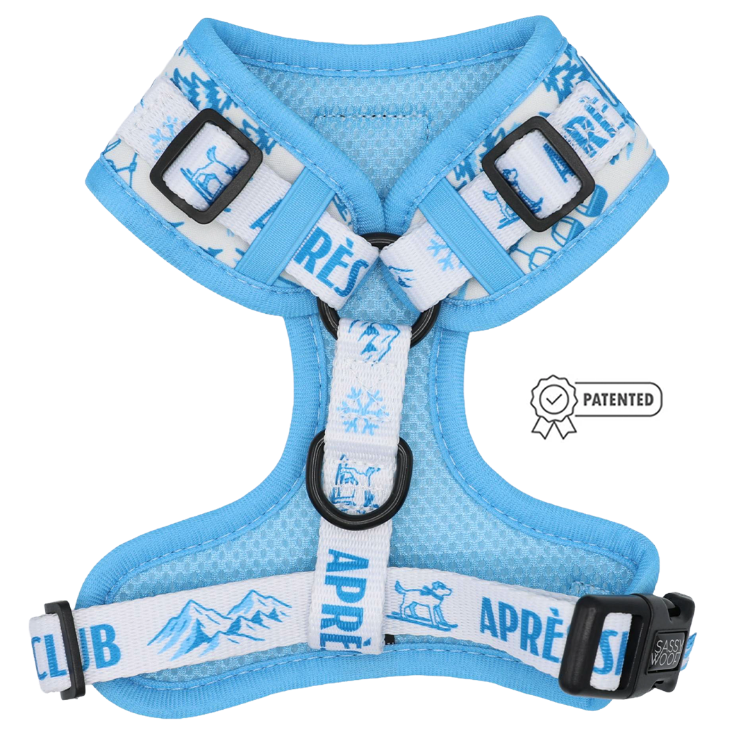 Introducing the Dog Adjustable Harness - Après Ski Club by Sassy Woof, a light blue and white custom printed neoprene harness adorned with snowy mountain, snowflake, and dog graphics. Featuring “APRÈS CLUB” on the straps and a patented badge on the side, this stylish adjustable harness offers both comfort and flair for your adventurous pup.