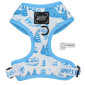 Introducing the Sassy Woof Dog Two Piece Bundle - Après Ski Club: This light blue and white harness features a stylish blue trim and winter-inspired illustrations of mountains, trees, skiers, and cozy cabins. The front showcases the signature Sassy Woof label alongside a Patented icon and bold APRES SKI text. Designed for both comfort and style, this adjustable harness pairs seamlessly with its matching cozy winter dog leash—perfect for your pup’s chilly-day adventures! Ensure your furry friend stays snug