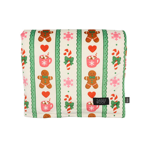 Wrap your furry friend in festive comfort with the Sassy Woof Pet Blanket - Cocoa & Cookies. This cozy winter blanket, part of the Cocoa & Cookies collection, features a cheerful pattern of gingerbread men, hearts, candy canes, pink snowflakes, and holiday mugs set against green and cream stripes. Finished with a black Sassy Woof tag sewn on the front, it makes a thoughtful gift for the holiday season.