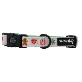 A white adjustable dog collar by Sassy Woof, featuring the Cocoa & Cookies design with colorful treats, a black buckle, and sturdy black D-ring. This neoprene collar is finished with signature Sassy Woof labels on both the buckle and side for a stylish touch.