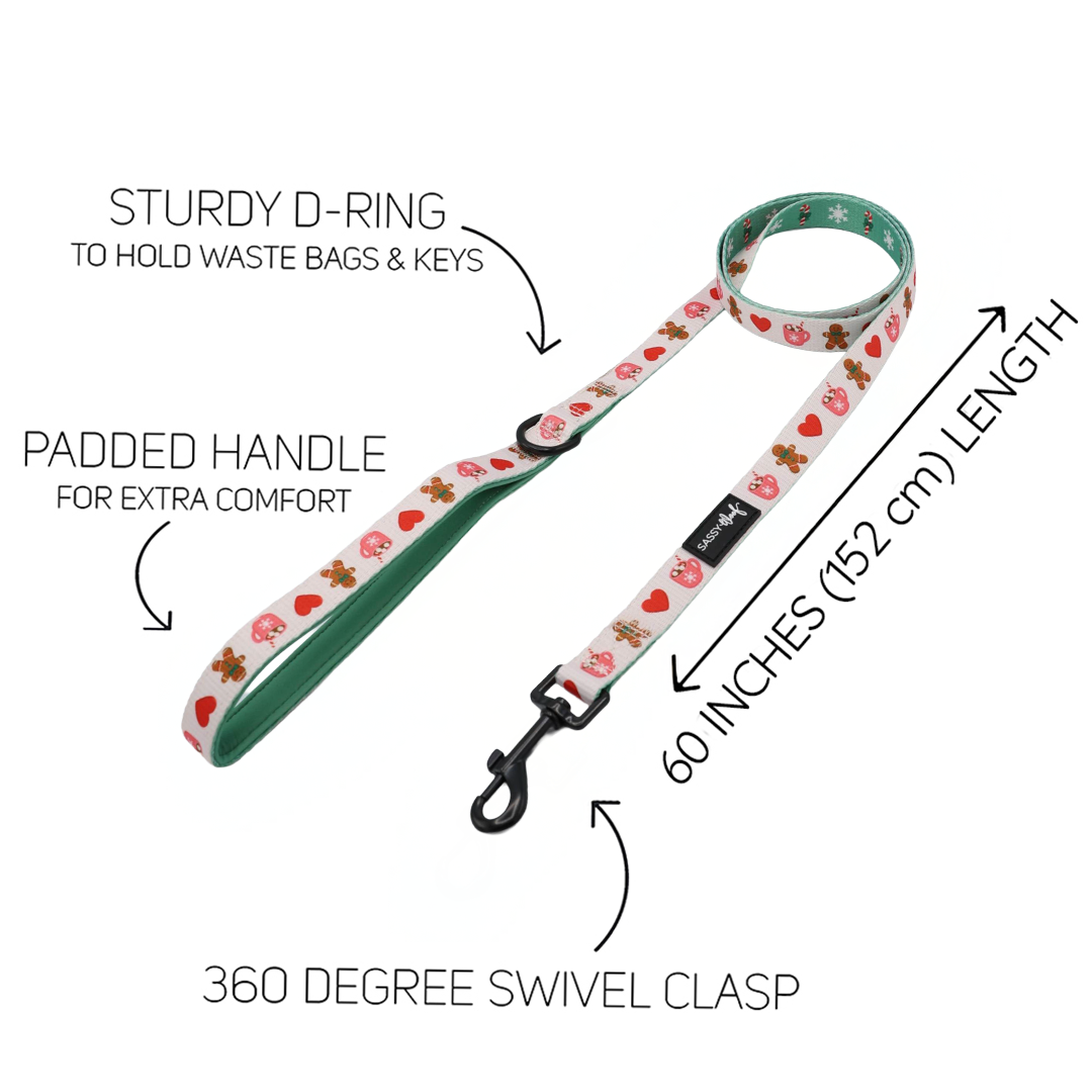 Introducing the Sassy Woof Dog Leash - Cocoa & Cookies: featuring a charming floral pattern from the Cocoa & Cookies collection, this 60-inch (152 cm) leash is designed with a soft neoprene handle for extra comfort, a sturdy D-ring, and a 360-degree swivel clasp. Text labels highlight each feature and it pairs perfectly with our adjustable harness.