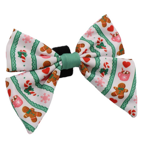 Dress up your pup this holiday season with the Dog Sailor Bow - Cocoa & Cookies by Sassy Woof, featuring a cheerful white background adorned with green trim, gingerbread men, candy canes, hearts, and snowflakes—perfect for pairing with your favorite pet accessories from the Cocoa & Cookies collection.