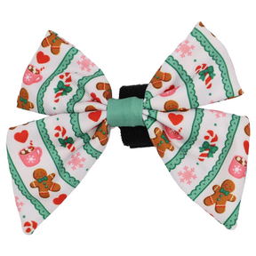 Add a sweet touch to your pet’s holiday look with the Sassy Woof Dog Sailor Bow - Cocoa & Cookies. Featuring festive green trim and a cheerful pattern of gingerbread men, candy canes, hearts, mugs, and pink snowflakes on a crisp white background, this bow is part of the Cocoa & Cookies collection. It pairs perfectly with an adjustable harness for both comfort and style during the holiday season.