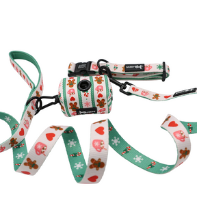 Celebrate the season with Sassy Woof’s Dog Collar Three Piece Bundle - Cocoa & Cookies, a cheerful set that includes a holiday dog collar, leash, and waste bag holder. This festive collection showcases playful hearts, candy canes, gingerbread cookies, and mushrooms arranged on a crisp white background with charming green and cream accents.