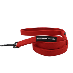 Red Hello Kitty® Chic dog harness and leash set featuring a black metal clip and a rectangular tag with the iconic logo.