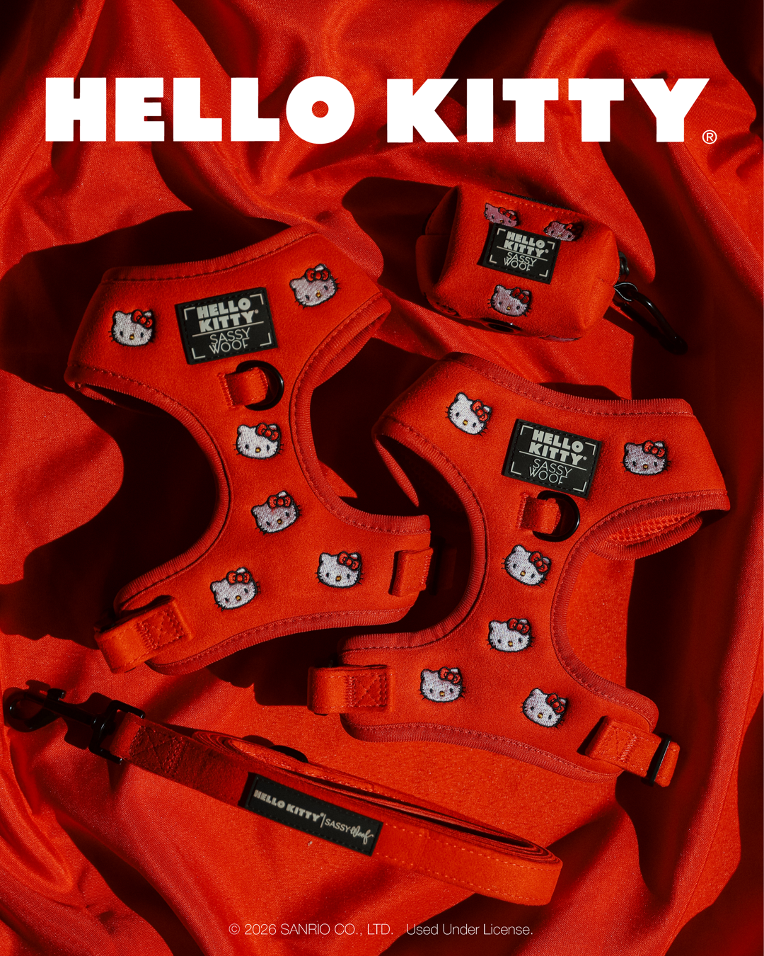 Two limited edition red Dog Adjustable Harness - Hello Kitty® Chic harnesses, a matching leash, and a waste bag dispenser, all featuring embroidered Hello Kitty face patterns.