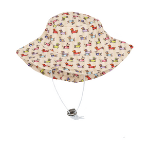 The Sassy Woof Dog Bucket Hat - Sunbean is a beige hat with a vibrant Doxie pattern and an adjustable white chin strap.