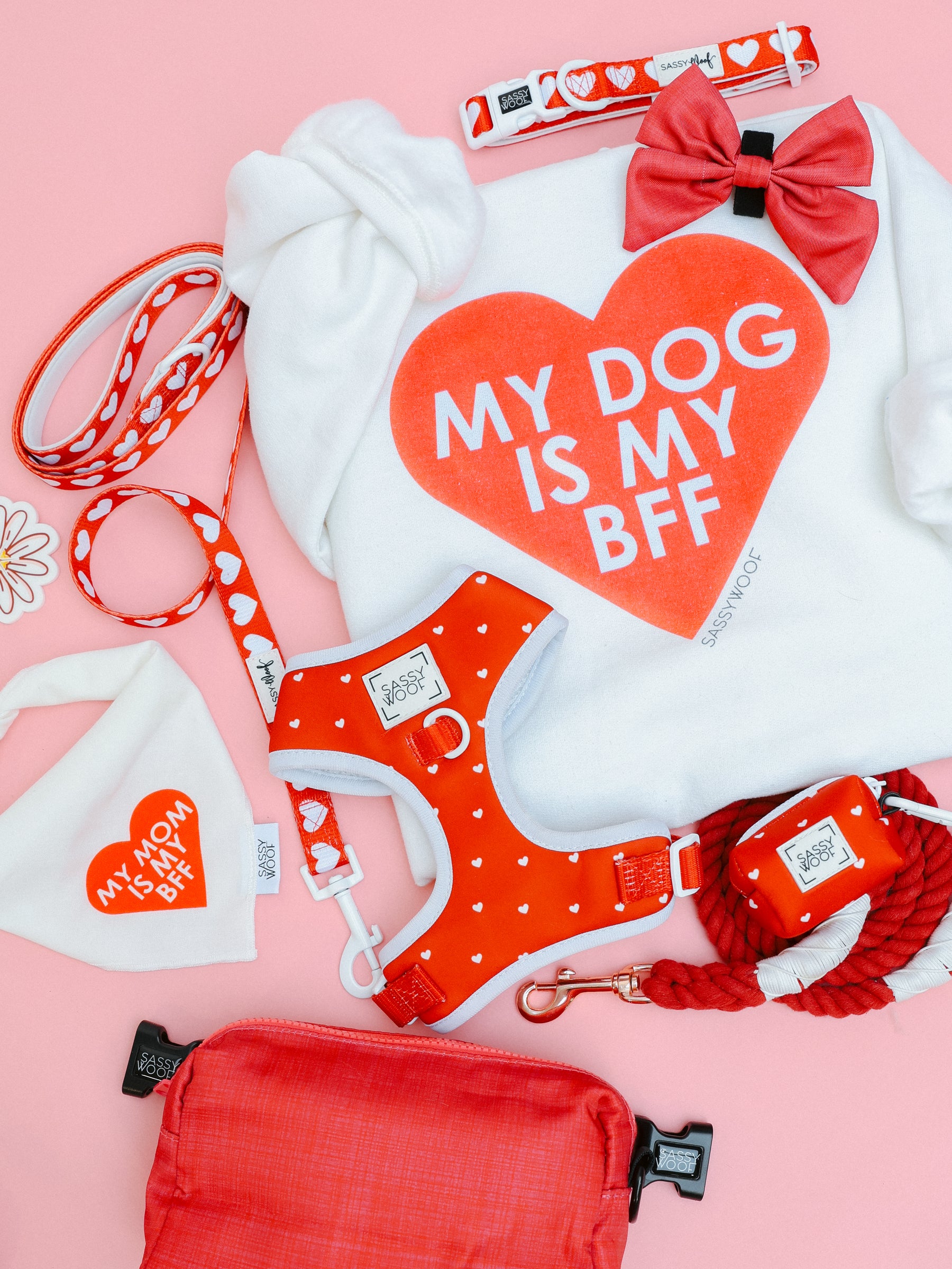 A flat lay of Sassy Woof’s red BFF Valentine's Sweatshirt & Bandana bundle for dogs, styled on a pink background—perfect for you and your furry best friend.
