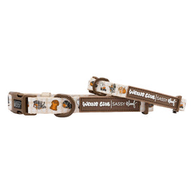 Two beige "Dog Collar - Weens Club" by Sassy Woof, both with brown trim, cartoon dachshund faces, and paw prints. One collar is flat, the other looped. Each features a brown label with Weens Club | Sassy Woof branding.