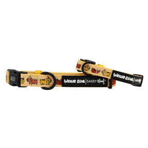Two yellow Hot Dawg dog collars from Sassy Woof with black plastic buckles, metal rings, playful dog illustrations, and Weens Club and Sassy Woof branding.
